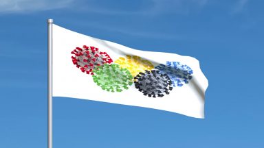 A flag flying showing colourful versions of the corona virus