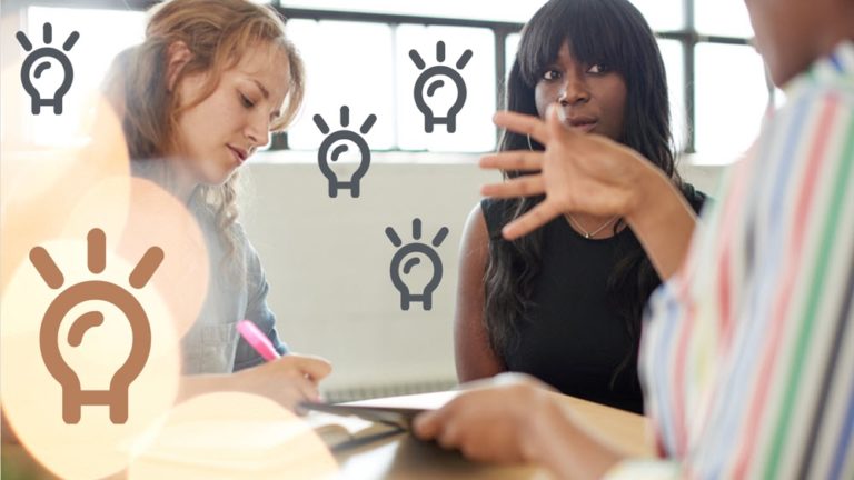 Generating ideas in a meeting represented by many lightbulbs floating above the conference table