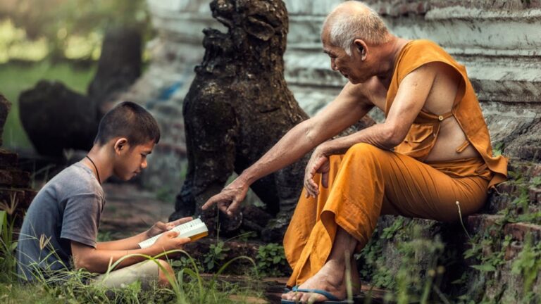Monk tutors a boy at a temple